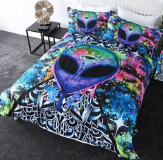 a bed with an alien head on it in a bedroom next to a night stand