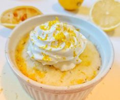 a small bowl filled with whipped cream and lemons