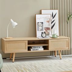 a living room with an entertainment center, clock and pictures on the wall behind it