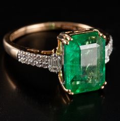 18k Yellow Gold Large Emerald Diamond Cocktail Style Ring 3.96ctw 3.82gMetal Information: 18k Yellow GoldTotal Weight: 3.82gBand Width: 1.4mmSize: 7Stone InformationMain StoneGem Type: EmeraldShape: Emerald (11.5mm x 8.0mm)Color: GreenClarity/Quality: ACarat Weight: 3.65ctNumber of Stones: 1Accent StonesGem Type: DiamondShape: Emerald (3.2mm x 2.2mm)Color: HClarity/Quality: SI1Carat Weight: .095ctNumber of Stones: 2Accent StonesGem Type: DiamondShape: Round (1.1mm)Color: HClarity/Quality: SI1Car Dope Jewelry Accessories, Golden Rings, Cute Engagement Rings, Golden Ring, Dope Jewelry, Gem Stone, Emerald Diamond, Emerald