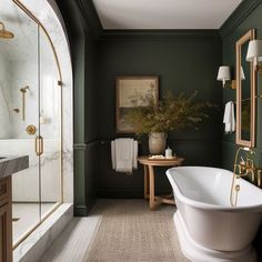 a bathroom with green walls and white bathtub