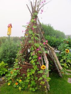 a small wooden structure made out of branches and flowers