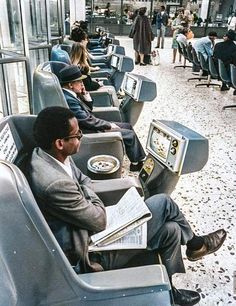 people sitting on seats in an airport waiting for their luggage