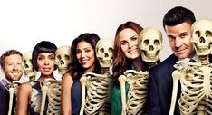 a group of people standing next to each other with skeleton heads