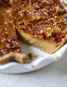 a close up of a pie on a plate with one slice cut out and ready to be eaten