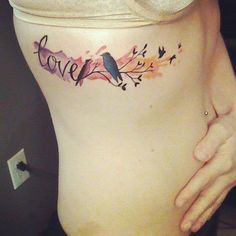 a woman's stomach with the word love painted on it and birds flying around