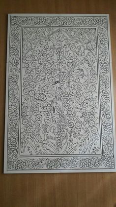 an intricately designed paper with flowers and vines on the edges is shown in black and white