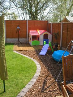 a backyard with a play area and wooden fence