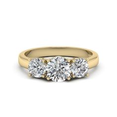 three stone engagement ring in yellow gold