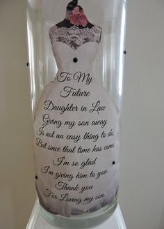 a glass vase with a dress on it that says to my father daughter in law