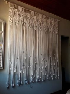 a white wall hanging on the side of a building