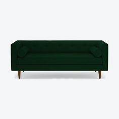 a green couch sitting on top of a white floor
