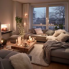 a living room filled with lots of furniture next to a large window covered in candles