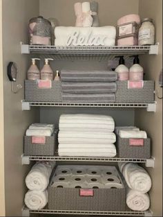 bathroom shelving with towels, soaps and other items in baskets on the shelves