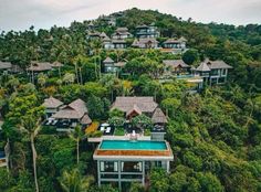 an aerial view of a resort surrounded by trees