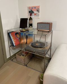 a record player sitting on top of a glass shelf