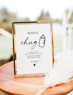 a sign that says bottle change on it next to a white feather and wooden table
