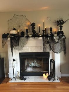 a fireplace decorated with halloween decorations and candles