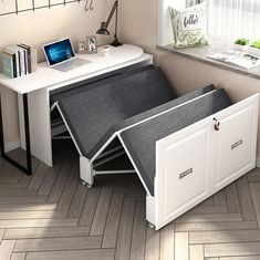 a desk with a laptop on top of it and an open drawer underneath the desk