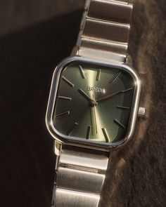 A modern approach to a distinctive and classic style. The Esther carries a bold 26mm square case, sun-ray moss green brushed dial and fastens with a silver-plated stainless steel bracelet. A style that transcends occasion or trend, created with timeless design in mind. Classy Watch, Vintage Watches Women, Retro Watches, Body Chains, Vintage Watches For Men, Dope Jewelry, Jewelry Lookbook, Classy Jewelry, Stylish Watches