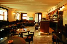 an empty restaurant with wooden tables and chairs