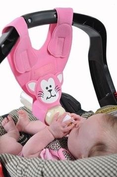 a baby laying in a car seat with a pink cat pacifier attached to it's mouth