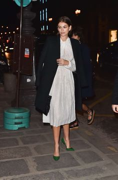 Kaia Gerber rocking a Flowing white draped midi dress with full sleeves, knoted bodice, a crew neck and flared hem Party In Paris, Paris Autumn, Kaia Gerber Style, Draped Midi Dress, White Drapes, Draped Midi Dresses, Kaia Gerber