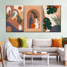 three paintings hang on the wall above a white couch in a living room with green and orange accents