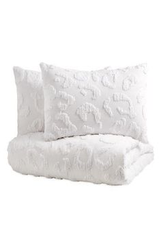 two white pillows sitting next to each other