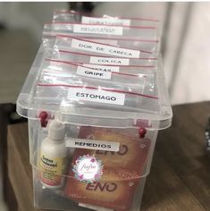 several plastic containers with labels on them sitting on a table