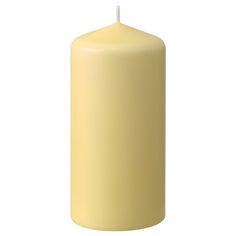 a yellow pillar candle on a white background