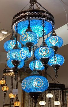 a chandelier with many blue lights hanging from it's ceiling in a store