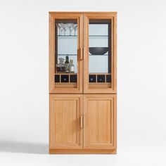 a tall wooden cabinet with glass doors on the front and bottom, holding wine glasses