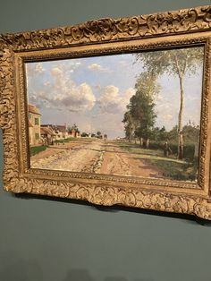 a painting hanging on the wall in a room