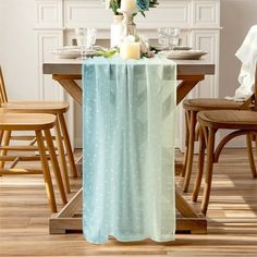 a dining room table with a polka dot table cloth and candles on the centerpiece