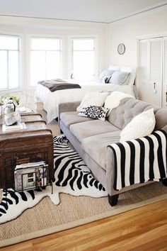 a living room with zebra rugs and two couches