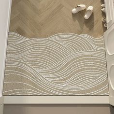 a bathroom with white and beige tile on the floor