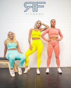 three women in neon colored clothing posing for the camera with their hands on their hipss