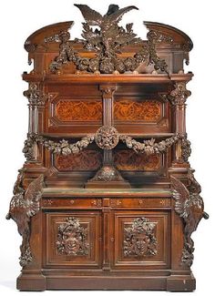 an ornate wooden cabinet with carvings on it