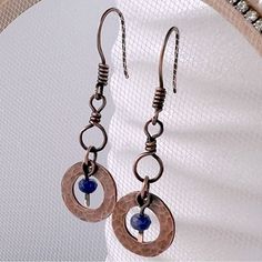 the earrings are made with copper and blue beads