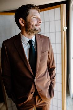 a man in a brown suit and tie