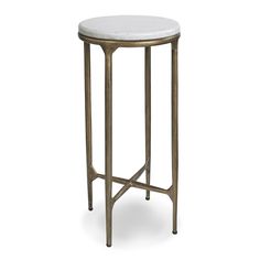 a white marble top side table with gold metal legs and a round shaped end table