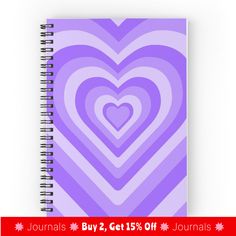a spiral notebook with a purple heart on the front and bottom, surrounded by smaller hearts