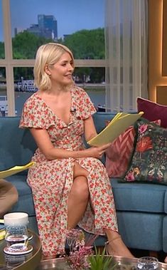 a woman sitting on top of a blue couch