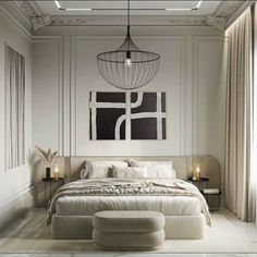 a large white bed sitting under a chandelier