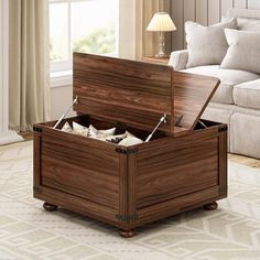 a wooden storage box sitting on top of a rug in a living room next to a couch