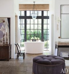 an image of a bathroom with a tub and large window in the background, on instagram