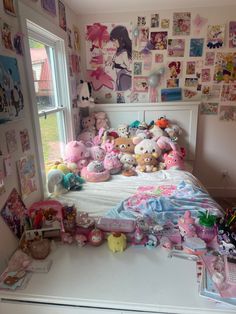 a bed with lots of stuffed animals and pictures on the wall next to it's windows