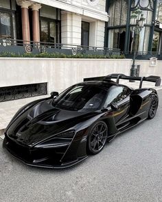 a black sports car parked in front of a building