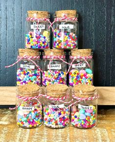 there are many jars that have different types of candy in them